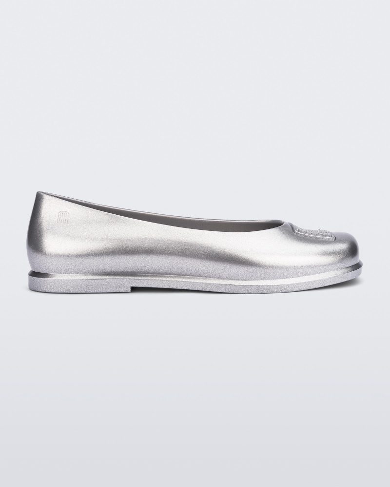 Side view of a metallic silver Ruby + Marc Jacobs flat