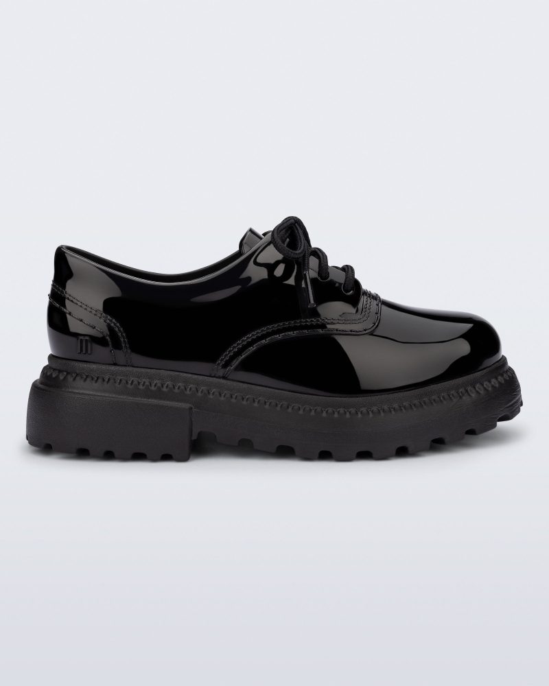 Side view of a black Charlotte adult sneaker loafer with laces