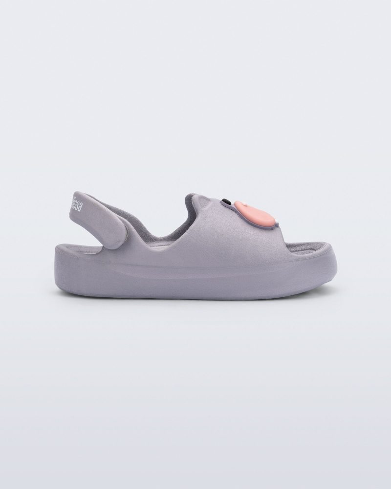 Side view of a grey Free Cute baby sandal with hippo face on front upper