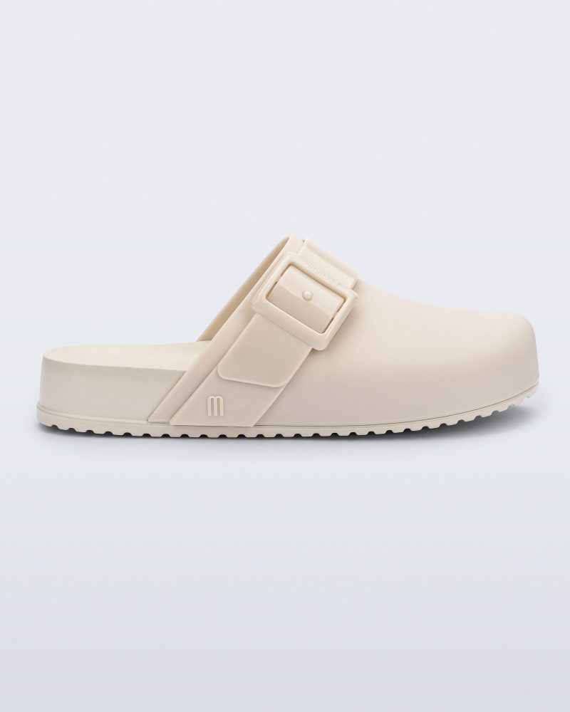 Side view of an adult beige Cozy Clog.