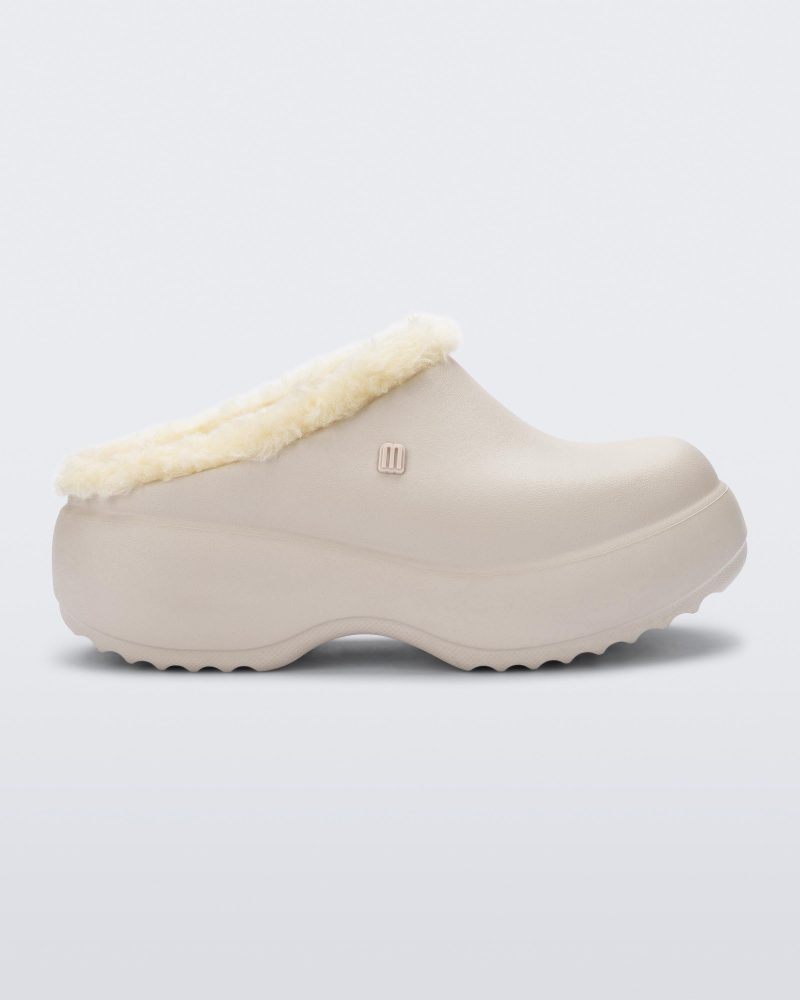 Side view of a beige Free Clog Fluffy Platform with light beige fluffy liner