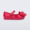 Side view of a red Sweet Love Snow White baby flat with a red bow with red apple center