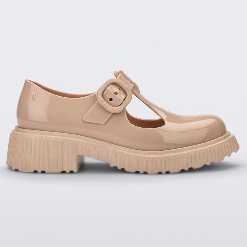 Side view of a beige Mini Melissa Jackie loafer with two cut outs and a buckle detail strap.