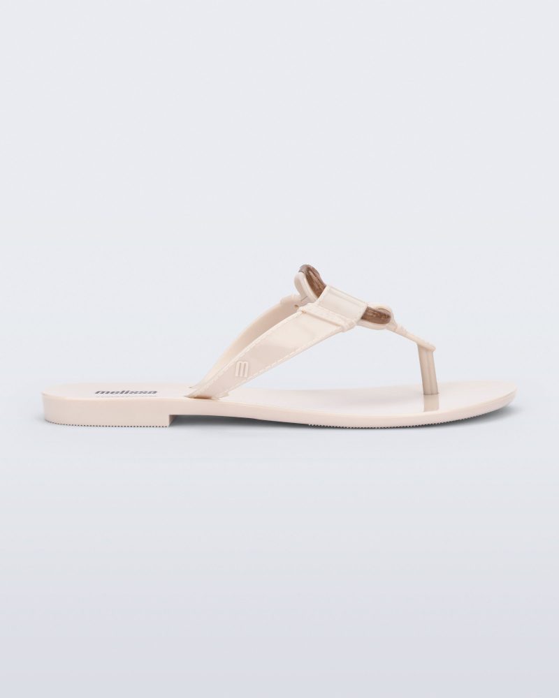 Side view of a beige Olivia adult flip flop