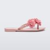 Side view of a pink Harmonic Springtime kids flip flop with three pink flowers.