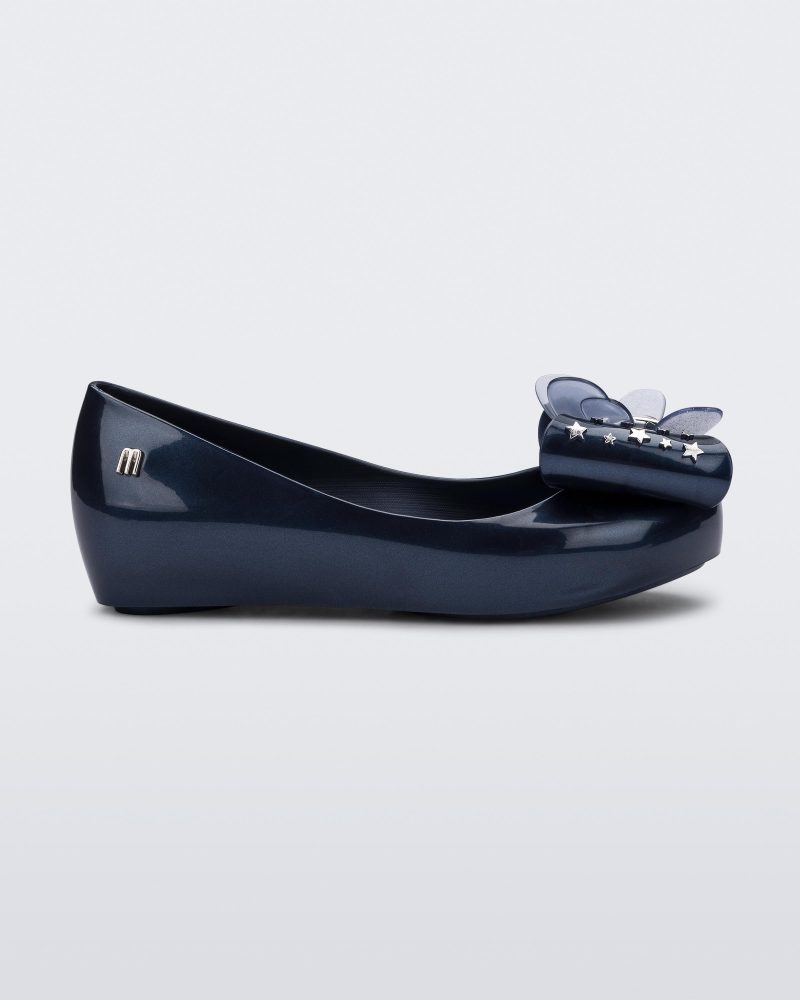 Side view of a Mini Melissa Ultragirl peeptoe ballet flat in blue with star printed butterfly bow applique.