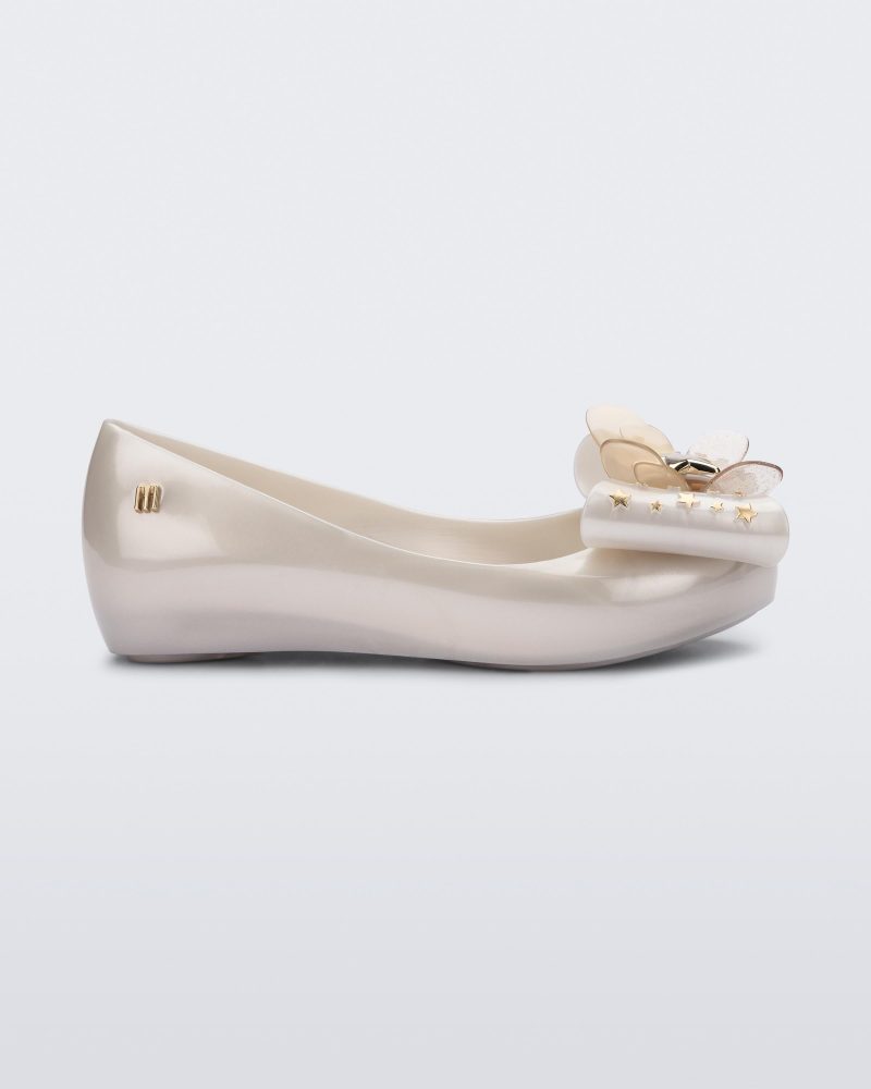 Side view of a Mini Melissa Ultragirl peeptoe ballet flat in white with star printed butterfly bow applique.