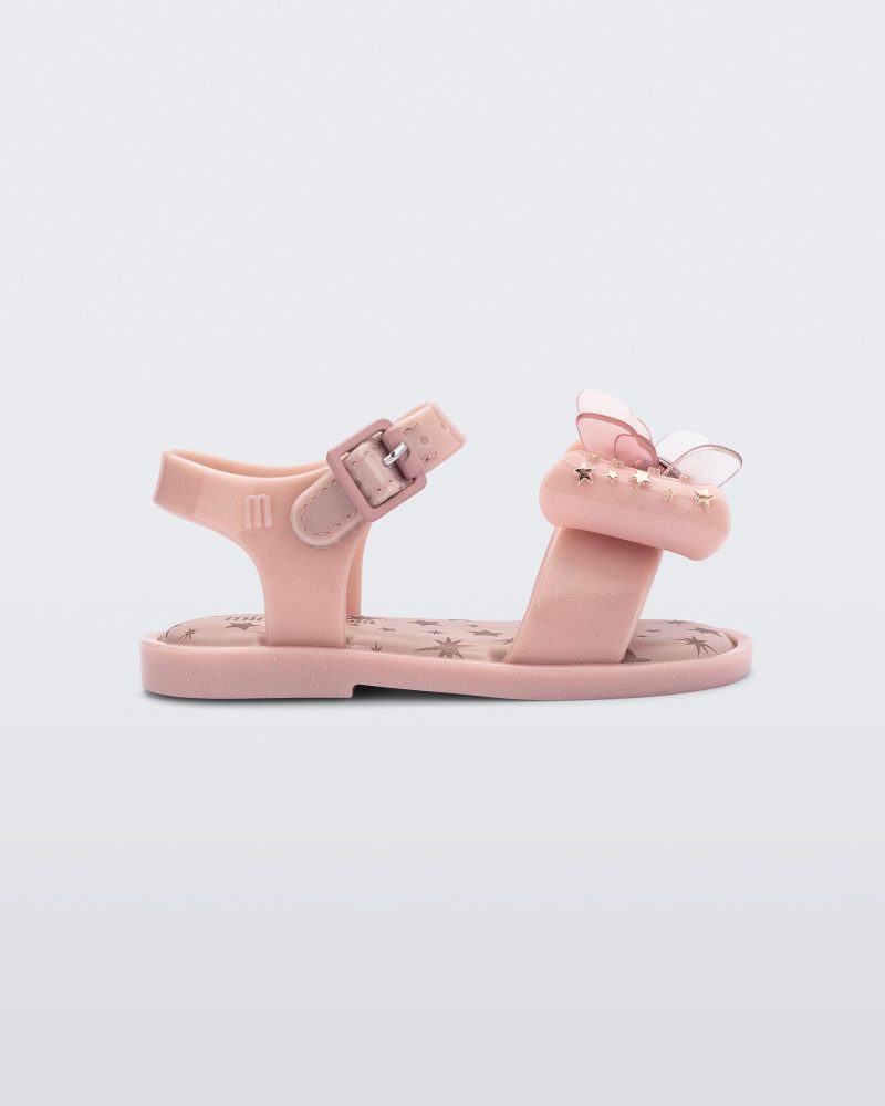 Side view of the Mini Melissa Mar Sandal with star print for baby in pink with butterfly bow applique and velcro closure on ankle strap.