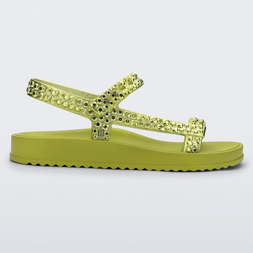 Side view of a green Lust sandal with metallic green strap