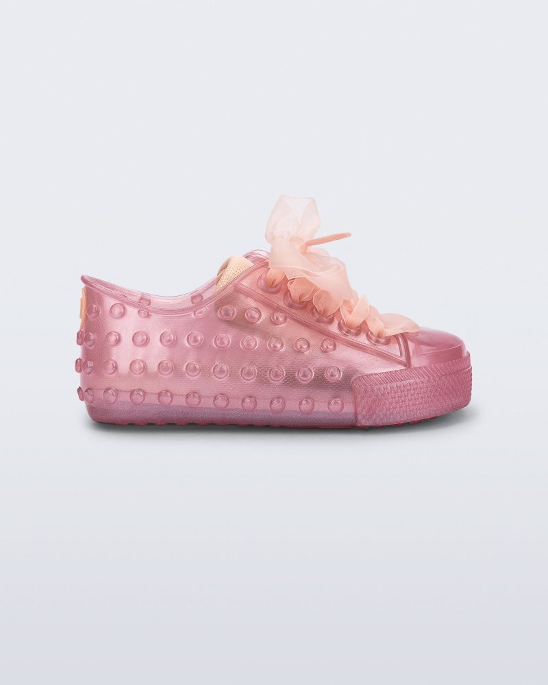 Side view of a pearly pink Polibolha baby sneaker with laces.