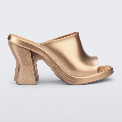 Side view of a gold Mule + Marc Jacobs heel