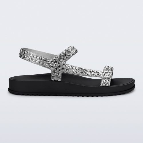 Side view of a black Lust sandal with silver strap