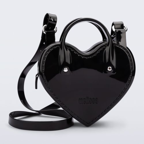 Front view of a black Heartbeat bag with small handles and longer strap.