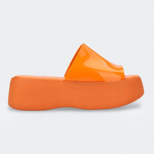 Side view of an orange Melissa Becky platform slide.