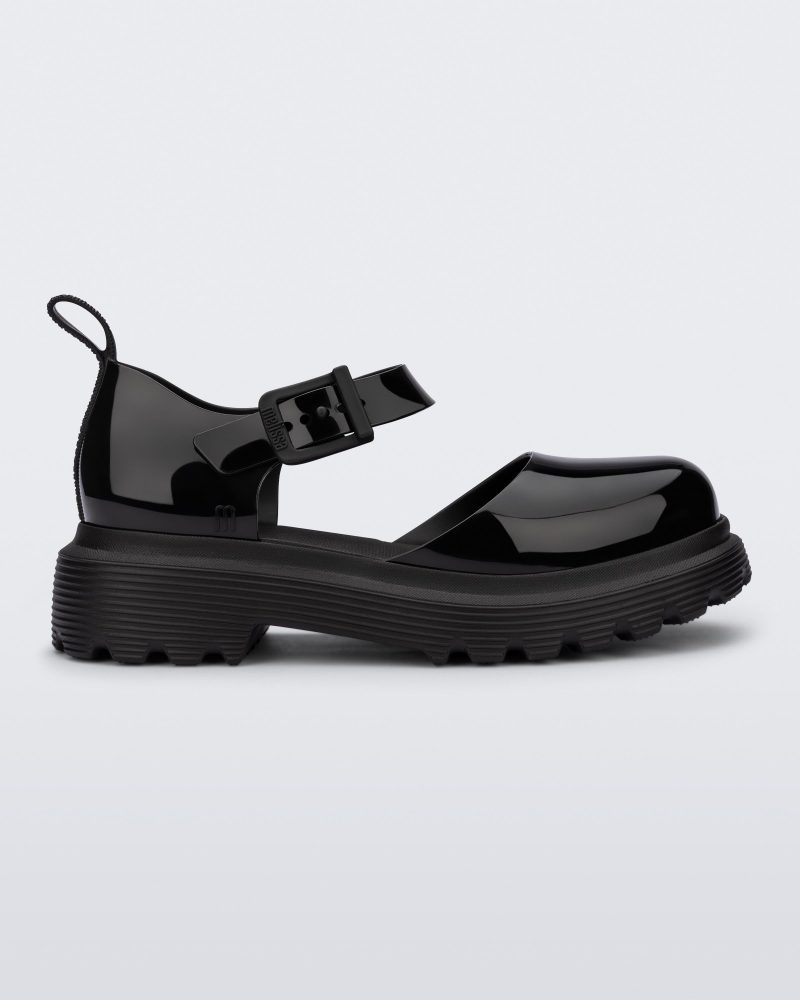 Side view of a black Ellie ankle strap loafer