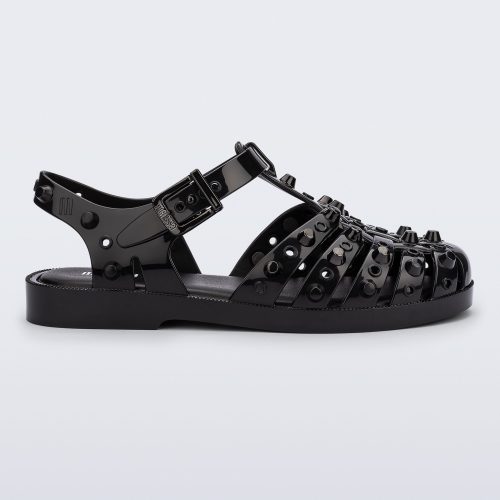 Side view of a black Possession Studs fisherman sandal with silver studs.