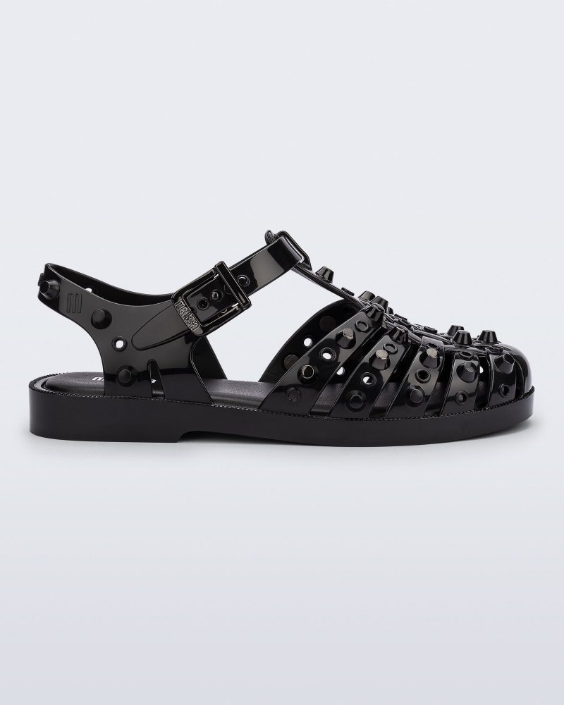 Side view of a black Possession Studs fisherman sandal with silver studs.