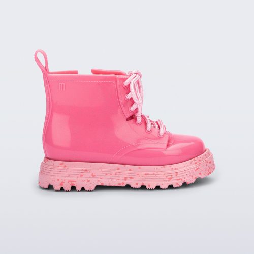 Side view of a pink Coturno baby boot with pink laces.