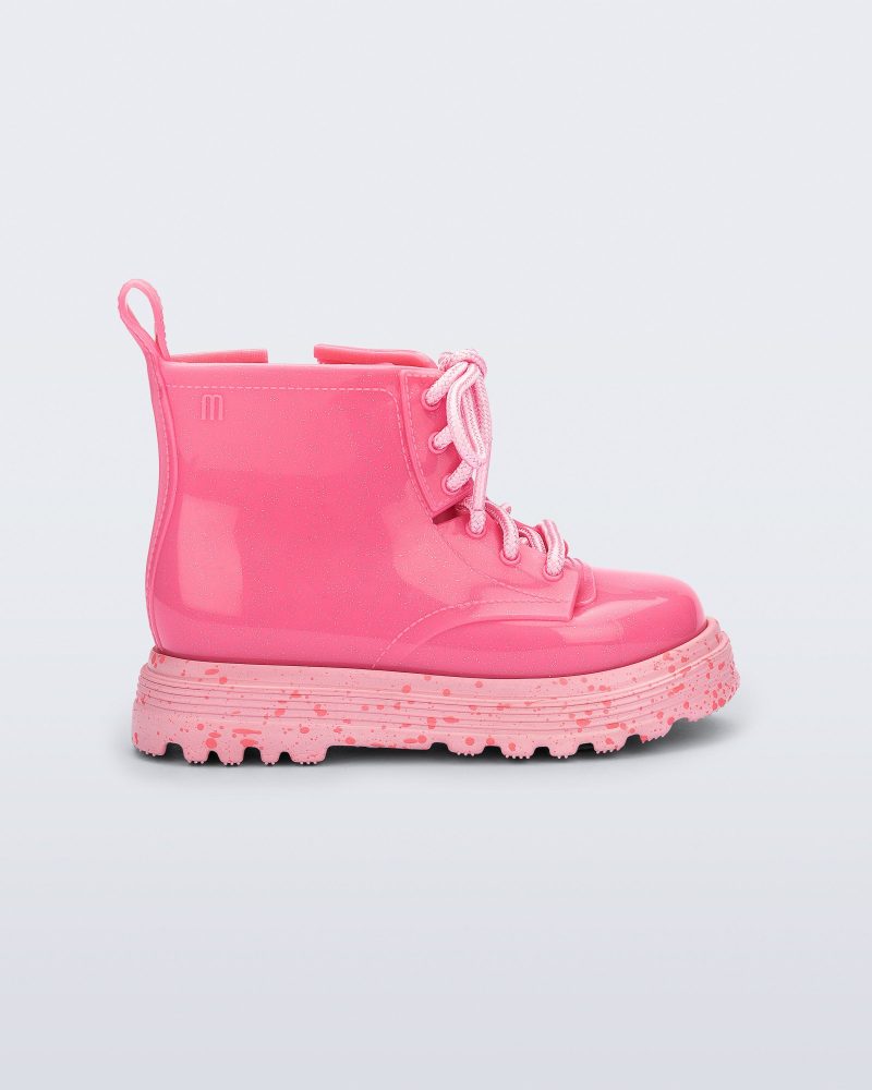 Side view of a pink Coturno baby boot with pink laces.