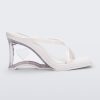 Side view of a white Glass Heel with a heart cutout in the heel.