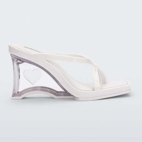 Side view of a white Glass Heel with a heart cutout in the heel.