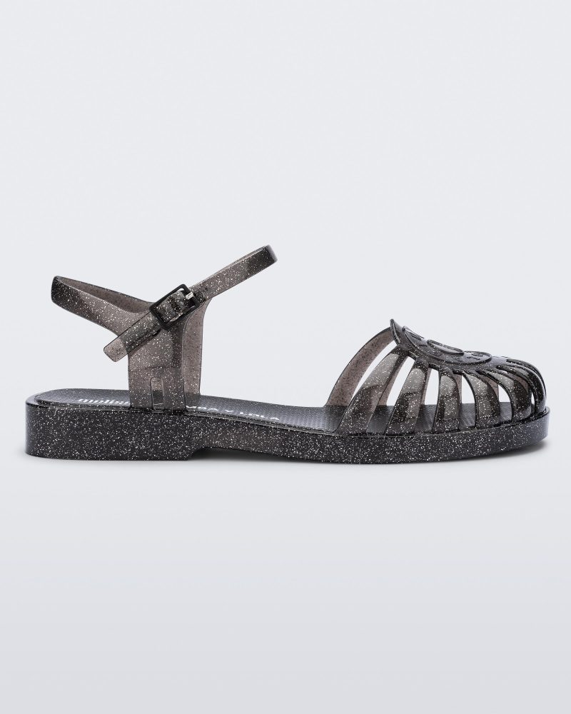 Side view of a glitter black Sandal + Bimba y Lola with ankle strap