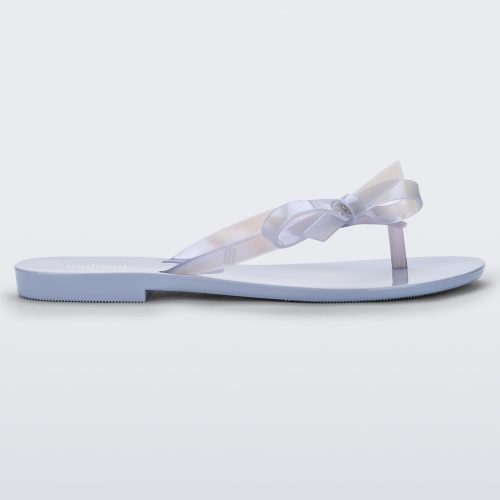 Side view of a Lilac/Pearly blue Melissa Harmonic Sweet flip flop with a lilac/pearly blue sole, straps and bow on top.