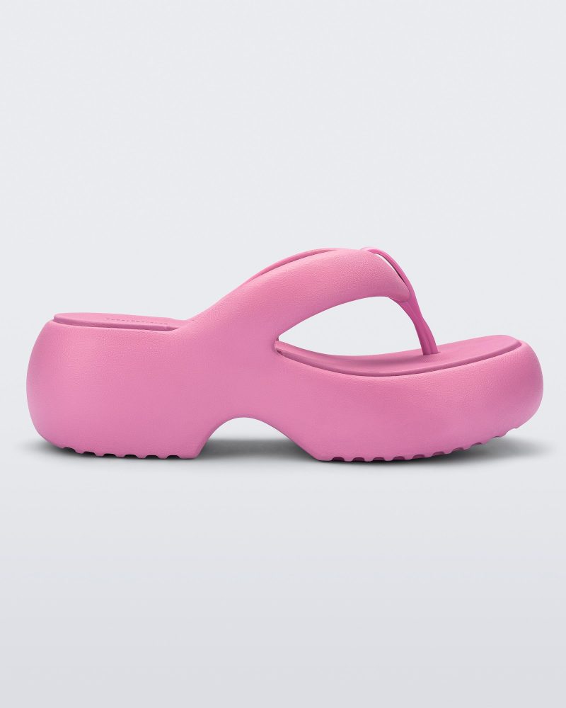 Side view of a pink Free Platform II flip flop