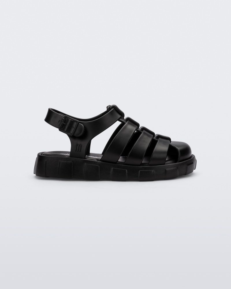 Side view of a black Megan baby sandal.