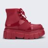 Side view of a red Rebel boot with laces