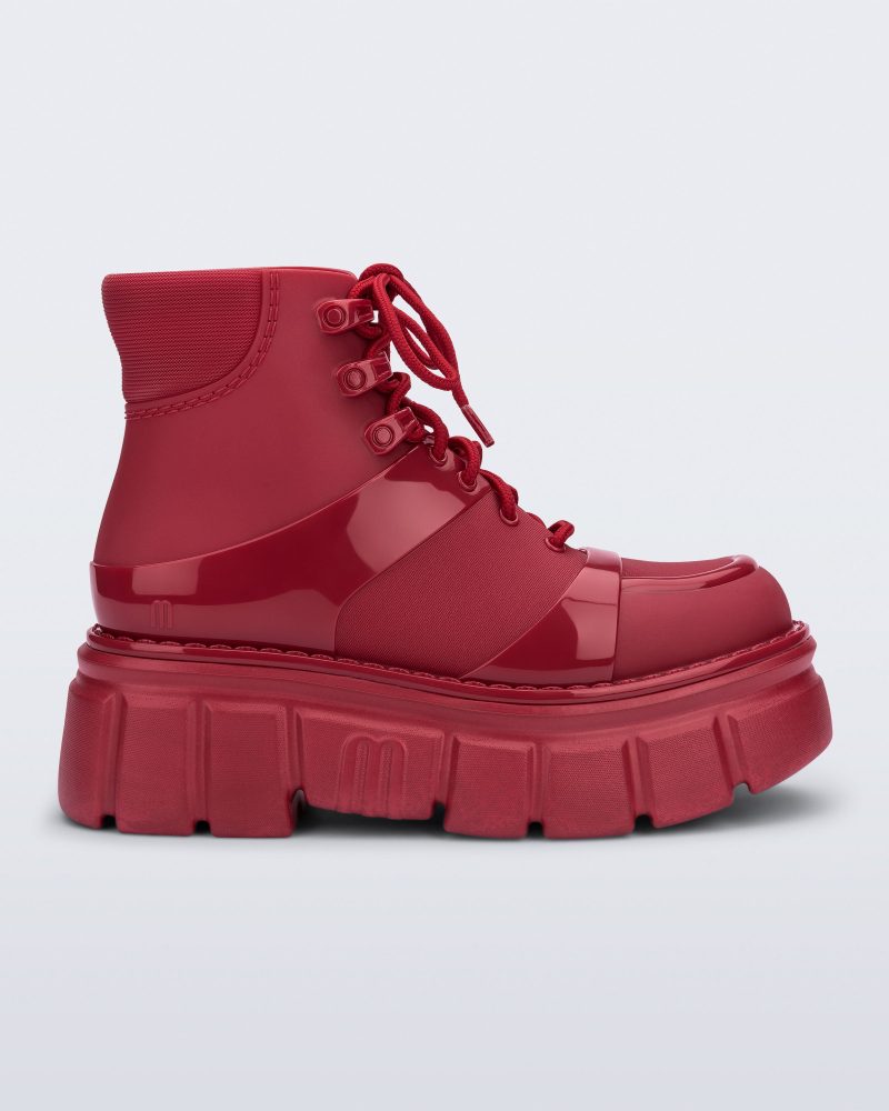 Side view of a red Rebel boot with laces