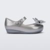 Side view of a pearly silver Ultragirl Sweet baby ballerina flat with bow