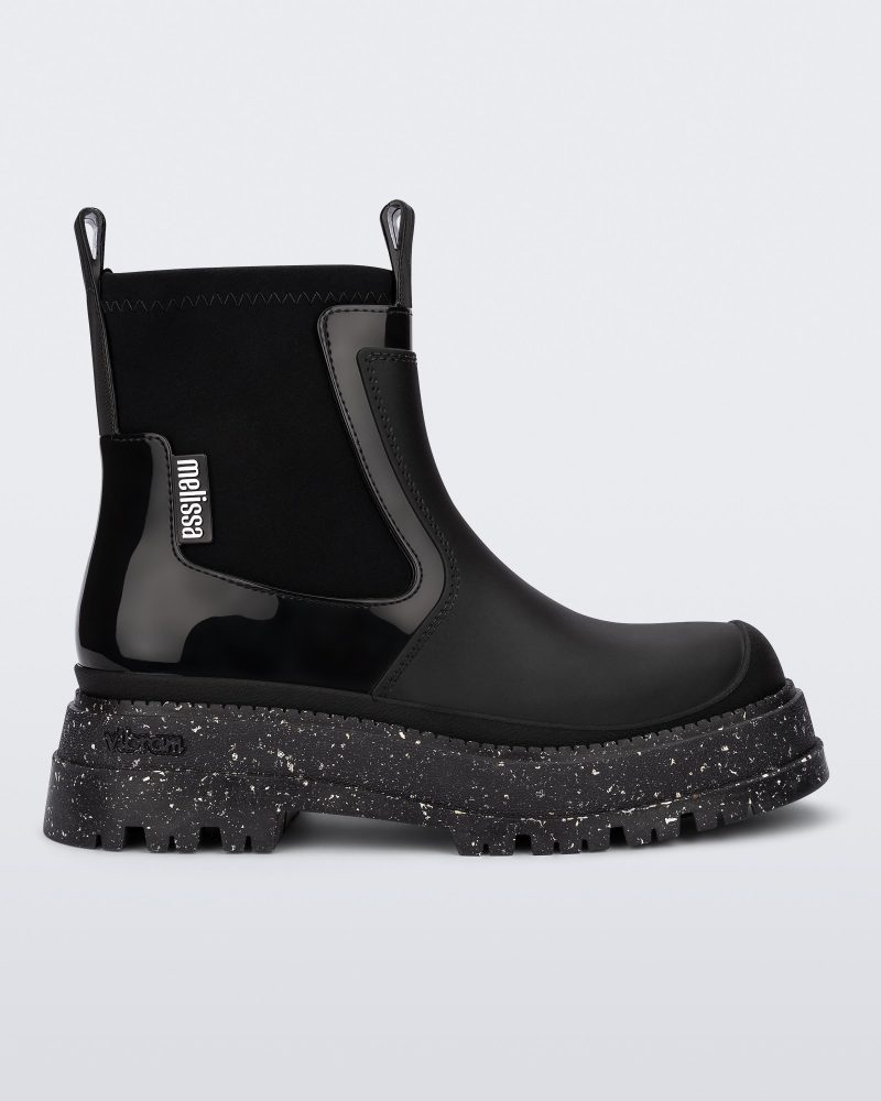 Side view of a black Drip Boot with speckled sole.