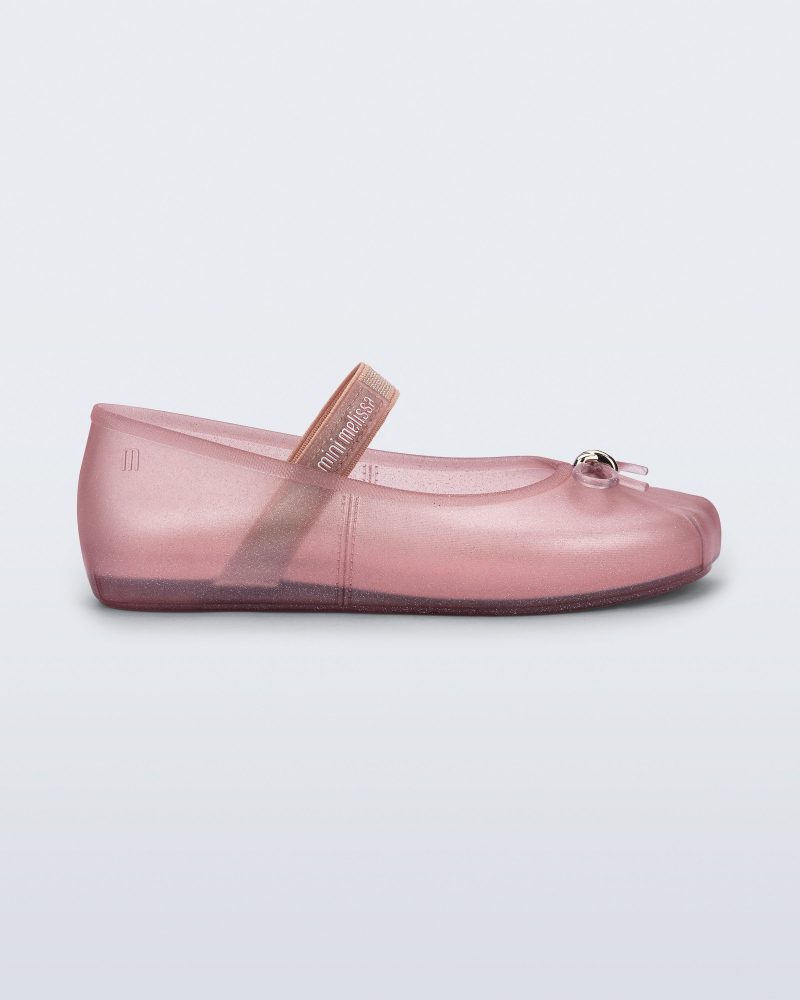 Side view of a pearly pink Sophie kids ballerina flat with bow