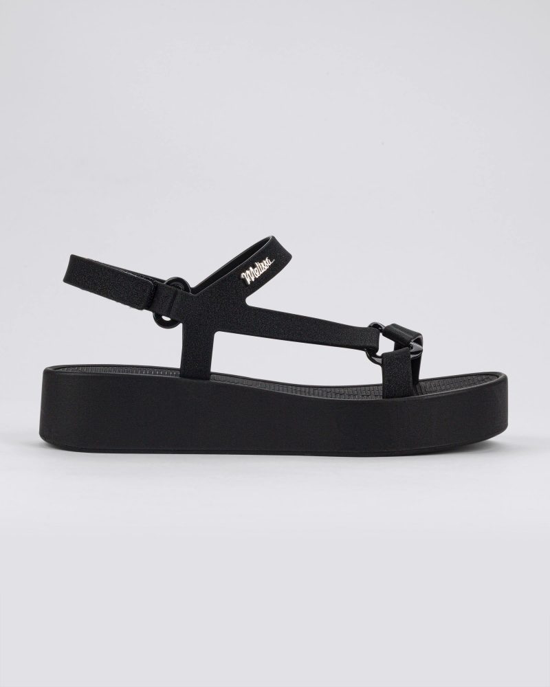 Side view of a black Sun Downtown Platform sandal.