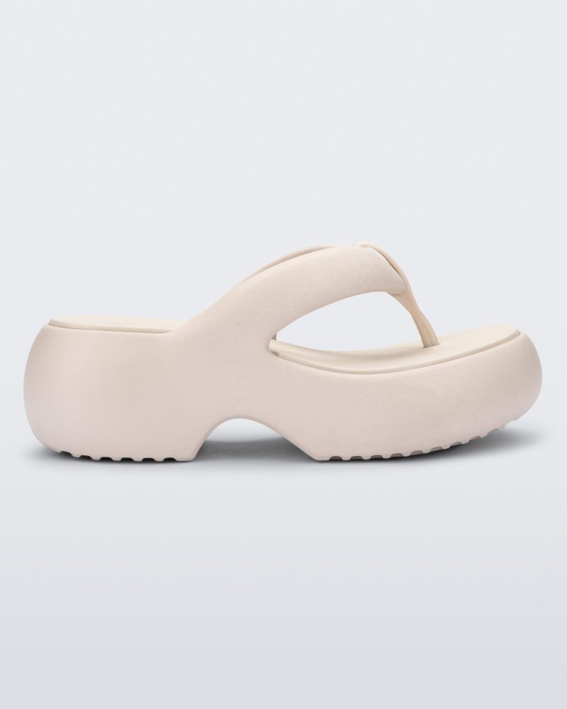 Side view of a beige Free Platform II flip flop