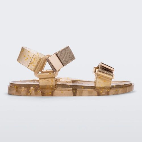 Side view of a Melissa Wide Papete sandal with transparent beige glitter sole and beige velcro straps.