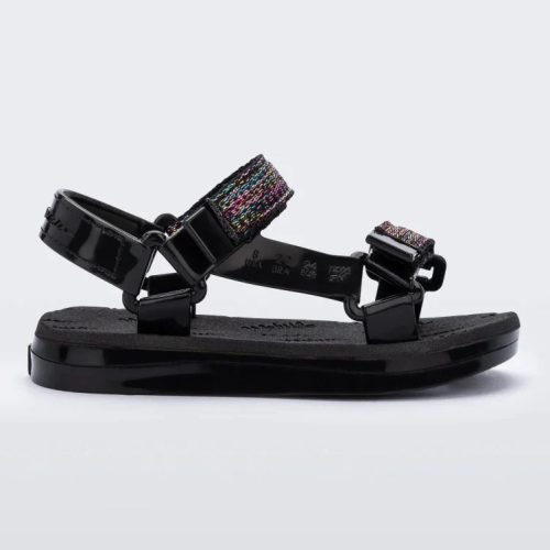 Side view of a black Mini Melissa Papete with glitter and black straps.