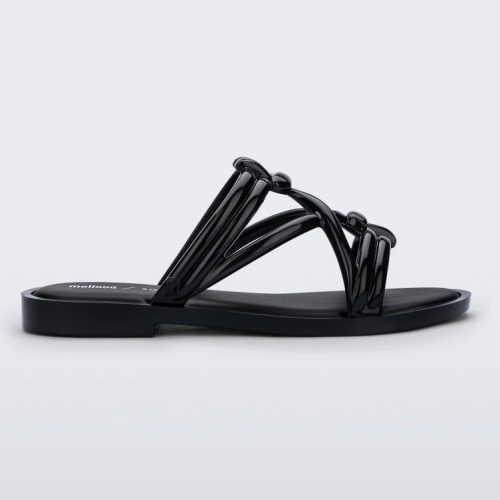 Side view of a black Melissa Wave Slide with several front straps with knot like details.