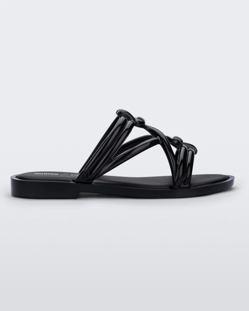 Side view of a black Melissa Wave Slide with several front straps with knot like details.