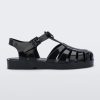 An outter side view of a black Mini Melissa Possession sandal with several straps and a black base.