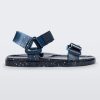 Side view of a blue/silver glitter Melissa Wide Papete sandal with velcro ankle and front straps.