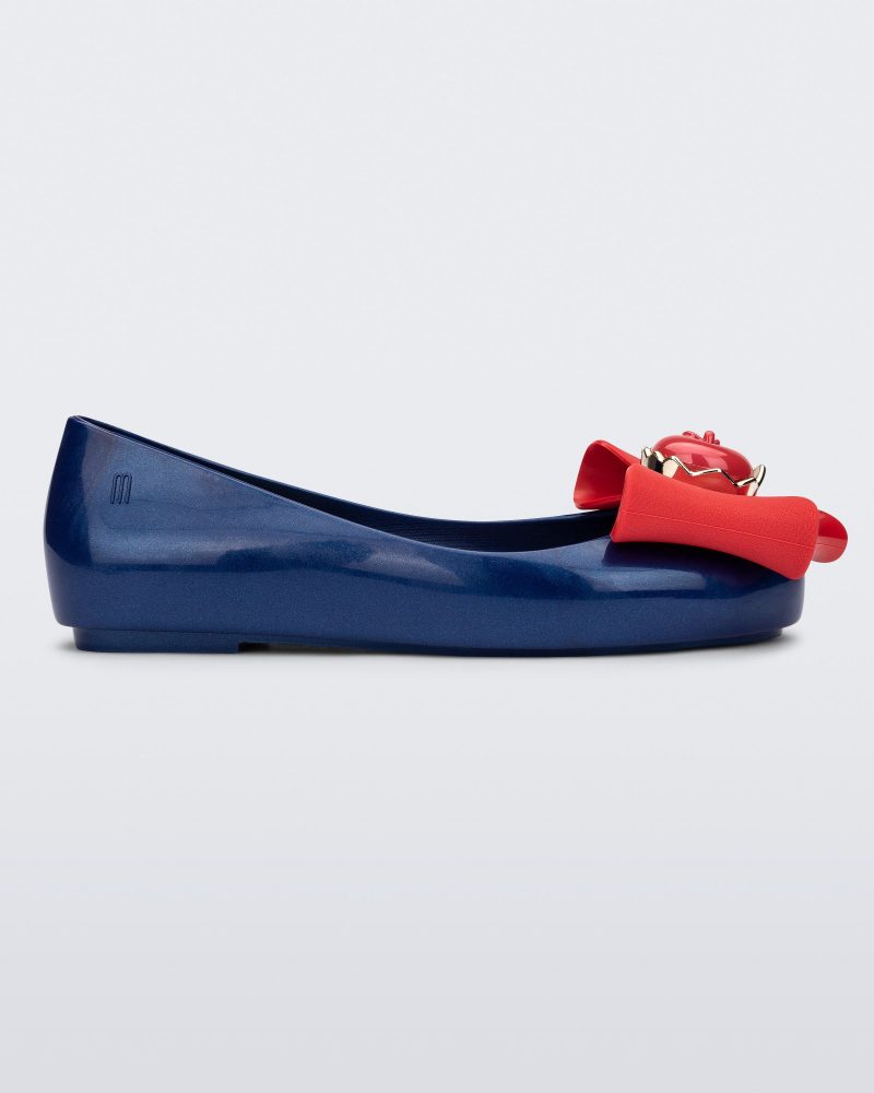 Side view of a blue Sweet Love Snow White kids flat with a red bow with red apple center