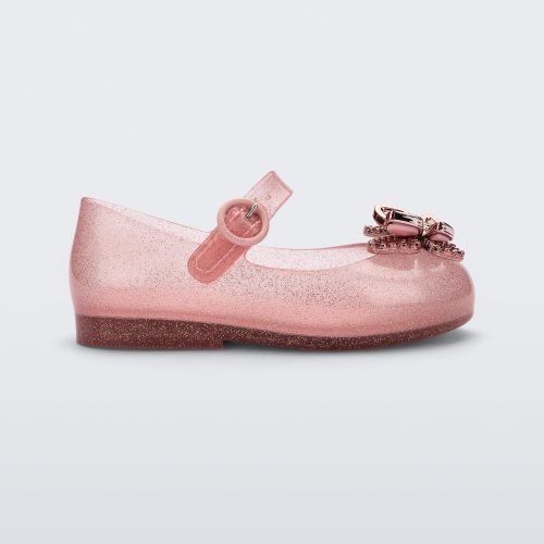 Side view of a glitter pink Mini Melissa Sweet Love Butterfly flat with a top strap and metallic pink butterfly detail on the toe