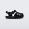 Side view of a black baby My First Mini Melissa Possession sandal