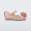 Side view of a pearly pink Ultragirl Springtime baby flat with two clear pink flowers and peep toe.