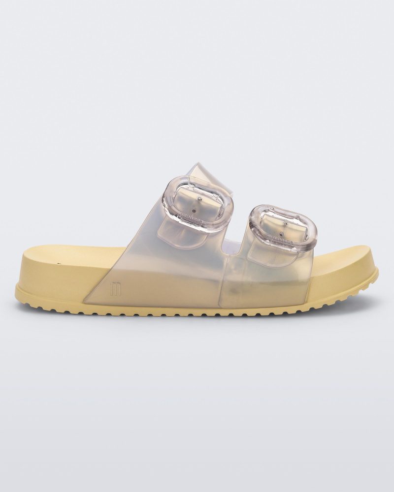 Side view of a pearly yellow Mini Melissa Cozy slide with two front straps with buckle details