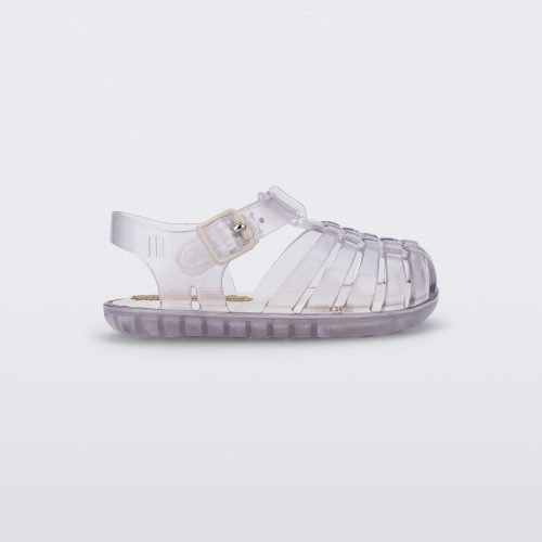 Side view of a clear baby My First Mini Melissa Possession sandal