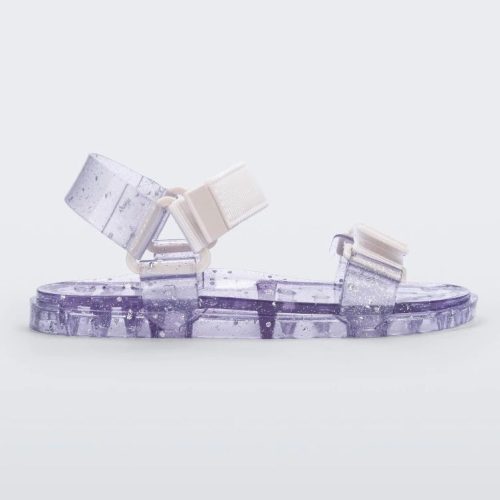 Side view of a Melissa Wide Papete sandal with transparent silver glitter sole with white/clear velcro straps