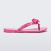 Side view of a pink Harmonic M Lover kids flip flop with Melissa logo on bow